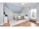 Cozy bedroom with a bed, side table, and a window, featuring hardwood floors at 3145 Sweet Basil Ln, Loganville, GA 30052