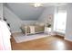 Bedroom with an angled ceiling, hardwood floors, a large rug, and a white metal bed frame at 3145 Sweet Basil Ln, Loganville, GA 30052