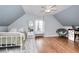 Light-filled bedroom with sloped ceilings, ceiling fan, and comfortable furnishings at 3145 Sweet Basil Ln, Loganville, GA 30052