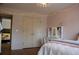 Stylish bedroom with string lights, creating a cozy atmosphere, featuring a double-door closet, and makeup station at 3145 Sweet Basil Ln, Loganville, GA 30052