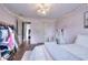 Pink bedroom featuring a closet, vanity, decorative lighting, and hardwood floors at 3145 Sweet Basil Ln, Loganville, GA 30052