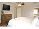 Bright bedroom featuring neutral walls, plush bed with white bedding, a TV, and access to the ensuite bathroom at 3145 Sweet Basil Ln, Loganville, GA 30052