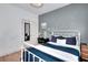 Well-lit bedroom with minimalist decor, hardwood floors, and window at 3145 Sweet Basil Ln, Loganville, GA 30052