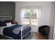 Cozy bedroom with modern decor, natural light, and hardwood floors at 3145 Sweet Basil Ln, Loganville, GA 30052