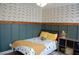 A nicely decorated bedroom featuring an accent wall and wood floors at 3145 Sweet Basil Ln, Loganville, GA 30052