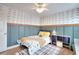 Bedroom with decorative walls, hardwood floors, ceiling fan, and natural light at 3145 Sweet Basil Ln, Loganville, GA 30052