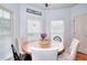 Eat-in kitchen area with a wooden table, cushioned chairs, and natural light at 3145 Sweet Basil Ln, Loganville, GA 30052