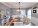 Cozy dining room with a rustic wooden table, decorative accents, and ample natural light creating an inviting atmosphere at 3145 Sweet Basil Ln, Loganville, GA 30052