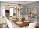 This dining room features a large table and view into the adjacent playroom at 3145 Sweet Basil Ln, Loganville, GA 30052