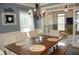 Formal dining room with wooden table and elegant chandelier at 3145 Sweet Basil Ln, Loganville, GA 30052