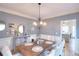 Elegant dining room with rustic wooden table, decorative chandelier, and stylish decor for memorable gatherings at 3145 Sweet Basil Ln, Loganville, GA 30052