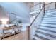 Inviting foyer with staircase, elegant table, mirror and hardwood floors at 3145 Sweet Basil Ln, Loganville, GA 30052