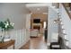 Inviting foyer with hardwood floors, staircase, and view of the living room with fireplace at 3145 Sweet Basil Ln, Loganville, GA 30052