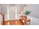 Inviting foyer featuring wood floors, console table with decor, mirror and natural light at 3145 Sweet Basil Ln, Loganville, GA 30052