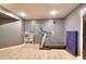 Home gym featuring a treadmill, storage shelf, and rubber flooring at 3145 Sweet Basil Ln, Loganville, GA 30052