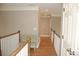 Hallway featuring wood floors, gray walls, white trim, and a bench with access to other rooms and doorways at 3145 Sweet Basil Ln, Loganville, GA 30052