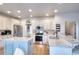 Bright kitchen with stainless steel appliances, granite countertops, and a blue island at 3145 Sweet Basil Ln, Loganville, GA 30052