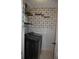 This laundry room features modern appliances and stylish floral wallpaper at 3145 Sweet Basil Ln, Loganville, GA 30052