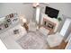 Open-concept living room with brick fireplace and airy, natural light at 3145 Sweet Basil Ln, Loganville, GA 30052