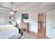 Elegant main bedroom featuring a tray ceiling, ceiling fan, and hardwood floors, creating a serene and inviting space at 3145 Sweet Basil Ln, Loganville, GA 30052