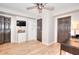Office with wood floors, storage cabinet, a TV, and doors at 3145 Sweet Basil Ln, Loganville, GA 30052