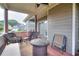 Cozy covered patio with wicker furniture, outdoor table, and ceiling fan, perfect for relaxation and entertaining at 3145 Sweet Basil Ln, Loganville, GA 30052