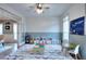Spacious playroom with half painted blue walls, hardwood floors and geometric patterned rug perfect for activities at 3145 Sweet Basil Ln, Loganville, GA 30052