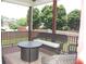 A covered porch with outdoor furniture, a fire pit, and wooded views at 3145 Sweet Basil Ln, Loganville, GA 30052