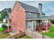 Two story home featuring brick and neutral siding, a wood fence, a back patio, and a well-maintained lawn at 3145 Sweet Basil Ln, Loganville, GA 30052