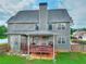 Two story home featuring well-maintained lawn, a wood fence, a back patio, and neutral siding at 3145 Sweet Basil Ln, Loganville, GA 30052