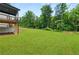 Private backyard features lush green grass and a wooded backdrop at 382 Tillman Pass, Woodstock, GA 30188
