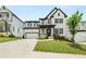 Charming two-story home featuring a spacious driveway, lush lawn, and attractive landscaping at 382 Tillman Pass, Woodstock, GA 30188