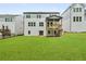 Back of home showcases a wood deck overlooking a spacious backyard at 382 Tillman Pass, Woodstock, GA 30188