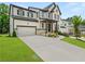 Beautiful two-story home with a two-car garage, manicured lawn, and welcoming front porch at 382 Tillman Pass, Woodstock, GA 30188