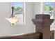Hallway with hanging pendant light fixture and wooden railing at 382 Tillman Pass, Woodstock, GA 30188