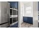 Kitchen featuring stainless steel appliances, built in oven and microwave, and navy cabinets at 382 Tillman Pass, Woodstock, GA 30188
