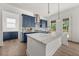 Stylish kitchen with a large island, quartz countertops, blue cabinets, and modern backsplash at 382 Tillman Pass, Woodstock, GA 30188