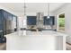 Modern kitchen featuring a large island with quartz countertops and stainless steel appliances at 382 Tillman Pass, Woodstock, GA 30188