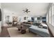 Open-concept living room with modern furnishings, hardwood floors, and seamless flow to kitchen at 382 Tillman Pass, Woodstock, GA 30188