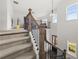 Staircase with carpet runner, wrought iron railing and wooden banister at 382 Tillman Pass, Woodstock, GA 30188