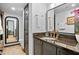 This bathroom has dark cabinetry, granite countertop, gold fixtures, and a large mirror at 4248 River Green Dr # 305, Atlanta, GA 30327