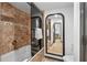 This bathroom has tiled walls, a glass door, and a view of the mirror into the next room at 4248 River Green Dr # 305, Atlanta, GA 30327