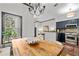 Charming dining area adjacent to the kitchen, featuring a rustic table and views of the exterior at 4248 River Green Dr # 305, Atlanta, GA 30327