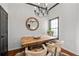 Bright dining area featuring a rustic wooden table, stylish seating, and a chic chandelier at 4248 River Green Dr # 305, Atlanta, GA 30327