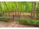 Fenced community dog park with seating and ample green space for pets to roam and play in a natural wooded setting at 4248 River Green Dr # 305, Atlanta, GA 30327