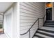 Close up of entryway with stairs, black door with wreath, and attached garage at 4248 River Green Dr # 305, Atlanta, GA 30327