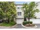 Charming townhome exterior features an attached garage, mature trees, and well-maintained landscaping at 4248 River Green Dr # 305, Atlanta, GA 30327