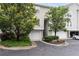 Townhome exterior features an attached garage, mature trees, and well-maintained landscaping in a community at 4248 River Green Dr # 305, Atlanta, GA 30327