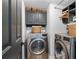 Well-equipped laundry room with modern front-load washer and dryer, plus ample storage at 4248 River Green Dr # 305, Atlanta, GA 30327
