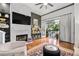 Stylish living room features a fireplace, hardwood floors, and access to a balcony with picturesque views at 4248 River Green Dr # 305, Atlanta, GA 30327